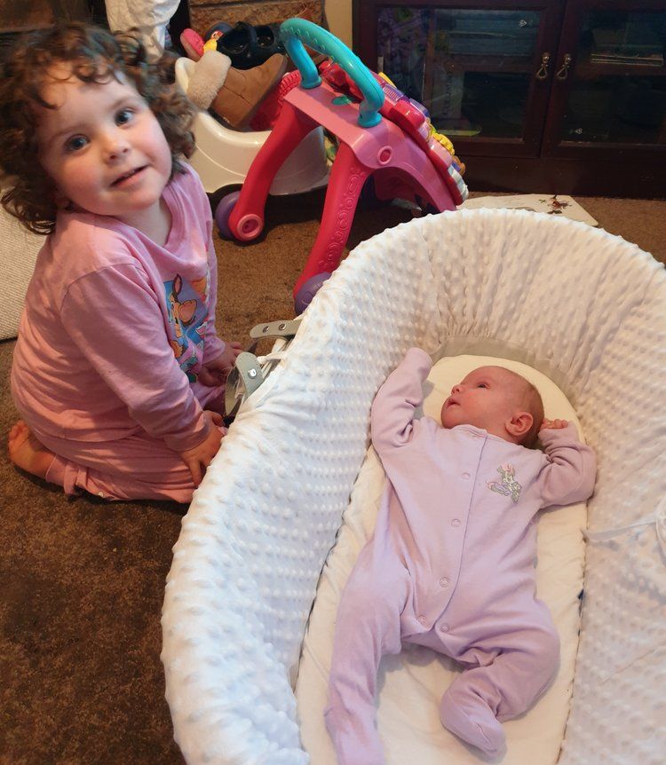 Baby Amelia with big sister Isobel