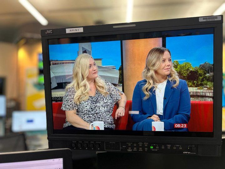 Camera screen showing two female presenters being filmed