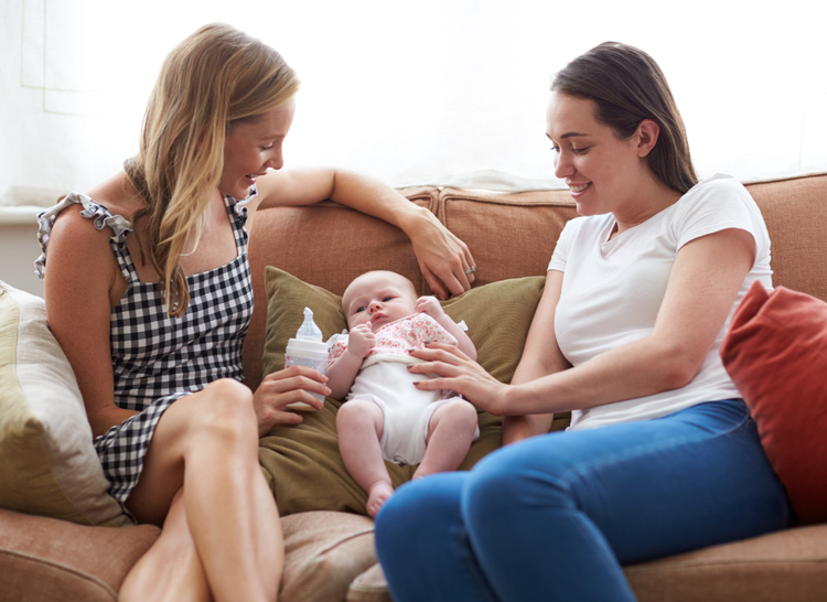 lesbian couple on the sofa with a baby