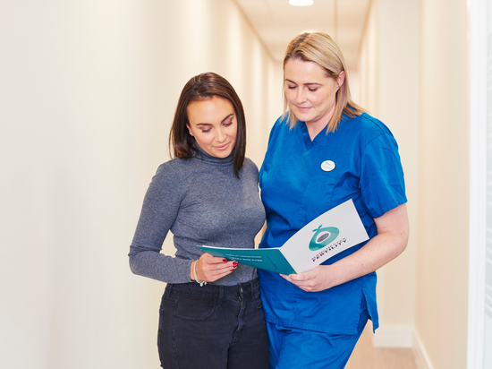 Two women at the clinic discussing frozen embryo transfer