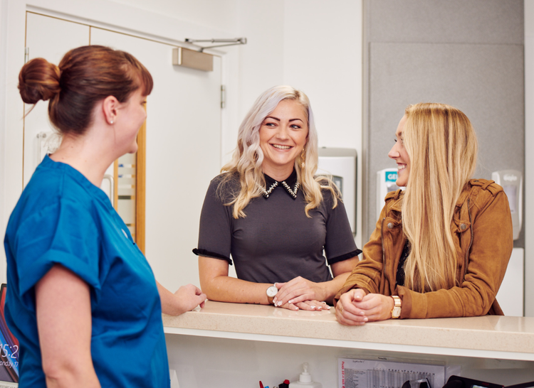Lesbian couple talking to one of the team members at Manchester Fertility