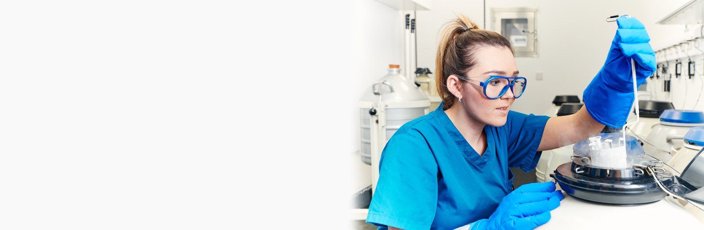 A nurse working with an egg freezing machine to help preserve fertility eggs