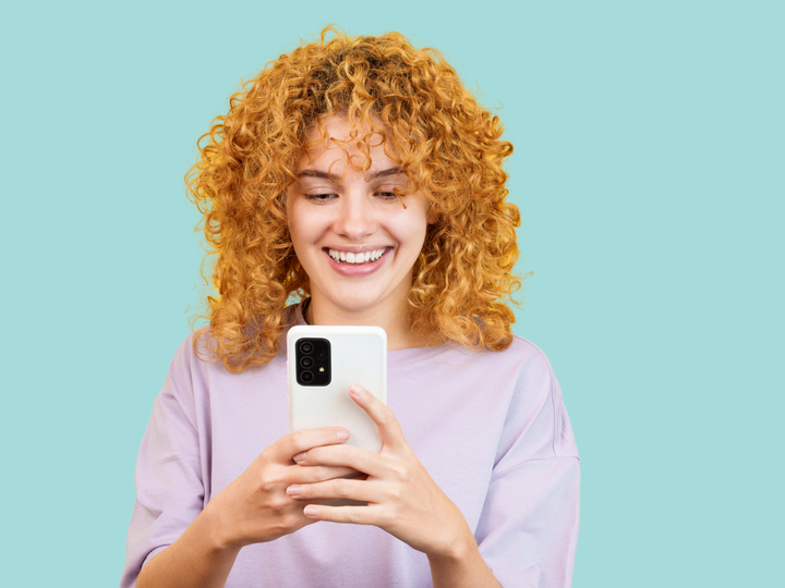 Women using her phone to access support during her two week wait
