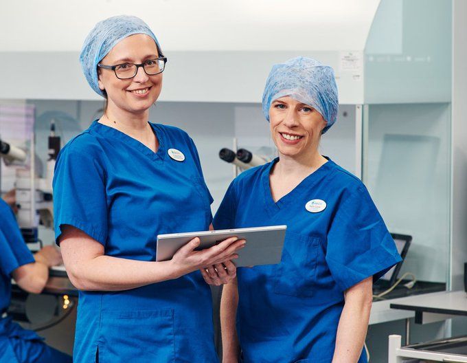Two doctors with tablet looking at IVF results