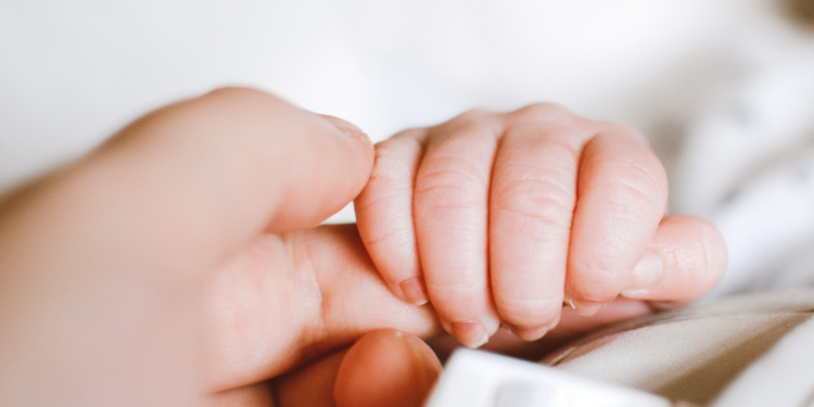 Baby holding parents finger - Early pregnancy reasurance scans at Manchester Fertility