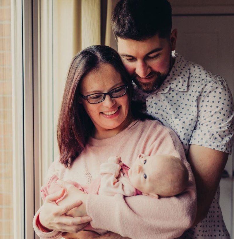 Baby Evie with parents Alex and Luke