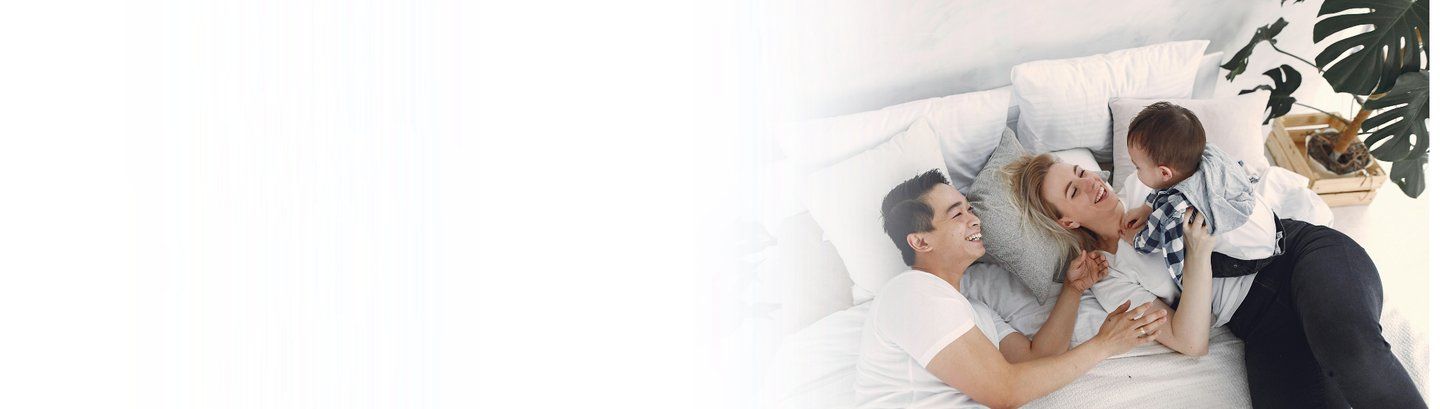 family simniling and cuddling - modified natural cycle ivf from manchester fertility