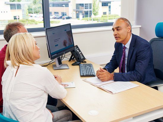 Dr Raj Mathur in consultation with a couple at Manchester Fertility