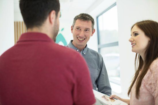 Doctor consulting two patients about their fertility assessment results